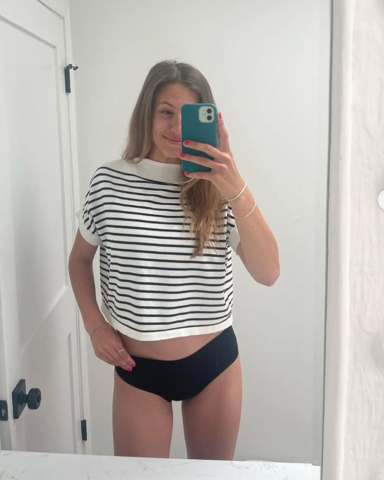 Person taking a mirror selfie wearing Fri Period's Low-rise Period Hipsters