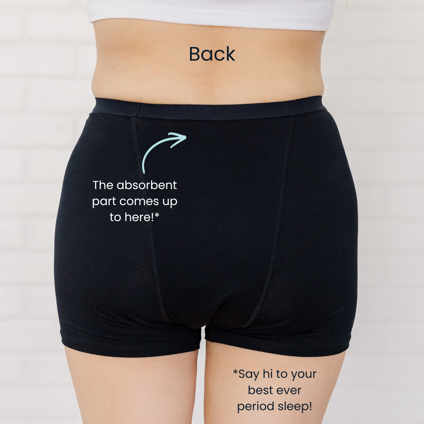 Black absorbent briefs worn by a person, showing the back with text indicating where the absorbent part is located.
